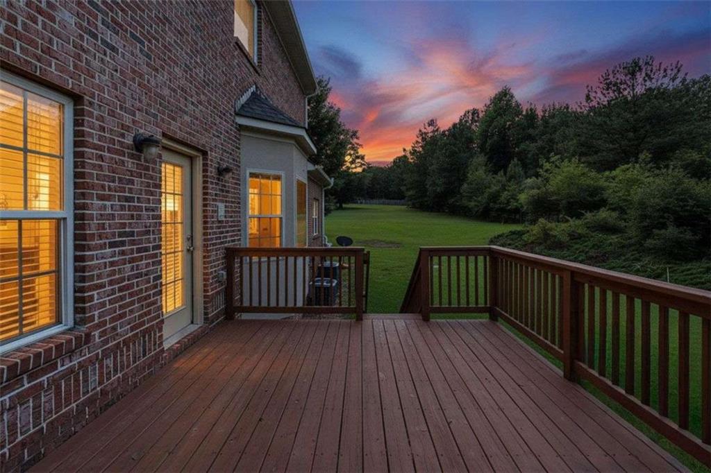 Rear deck and expansive lawn at twilight