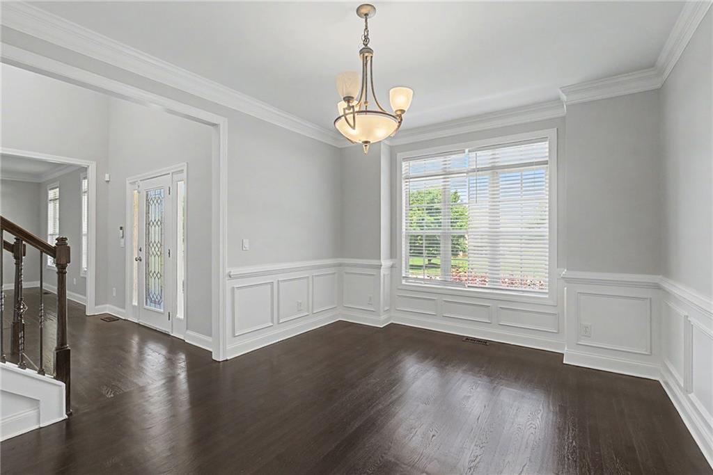 Formal dining room with wainscoting and chandelier