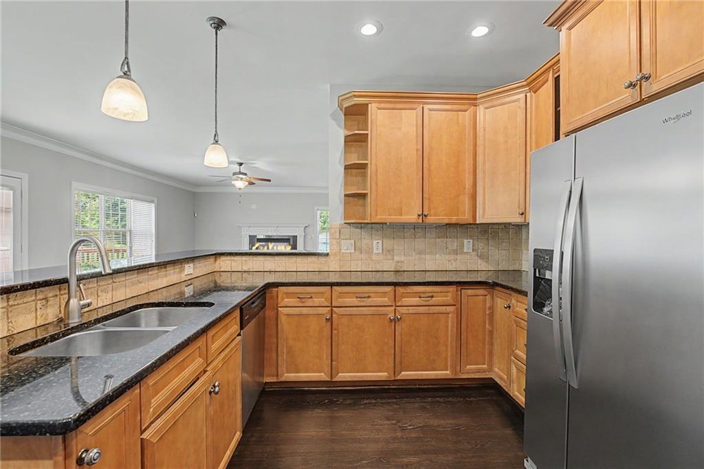 Kitchen with warm wood cabinetry and stainless-steel appliances